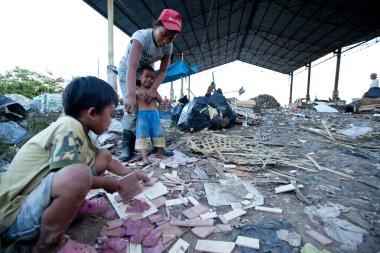 BALI, INDONESIA  APRIL 11: Poor from Java island working in a scavenging at the dump on April 11, 2012 on Bali, Indonesia. Bali daily produced 10,000 cubic meters of waste.